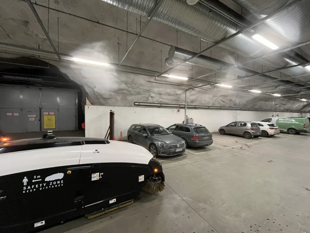 Trombia autonomous sweeper inside a parking garage.